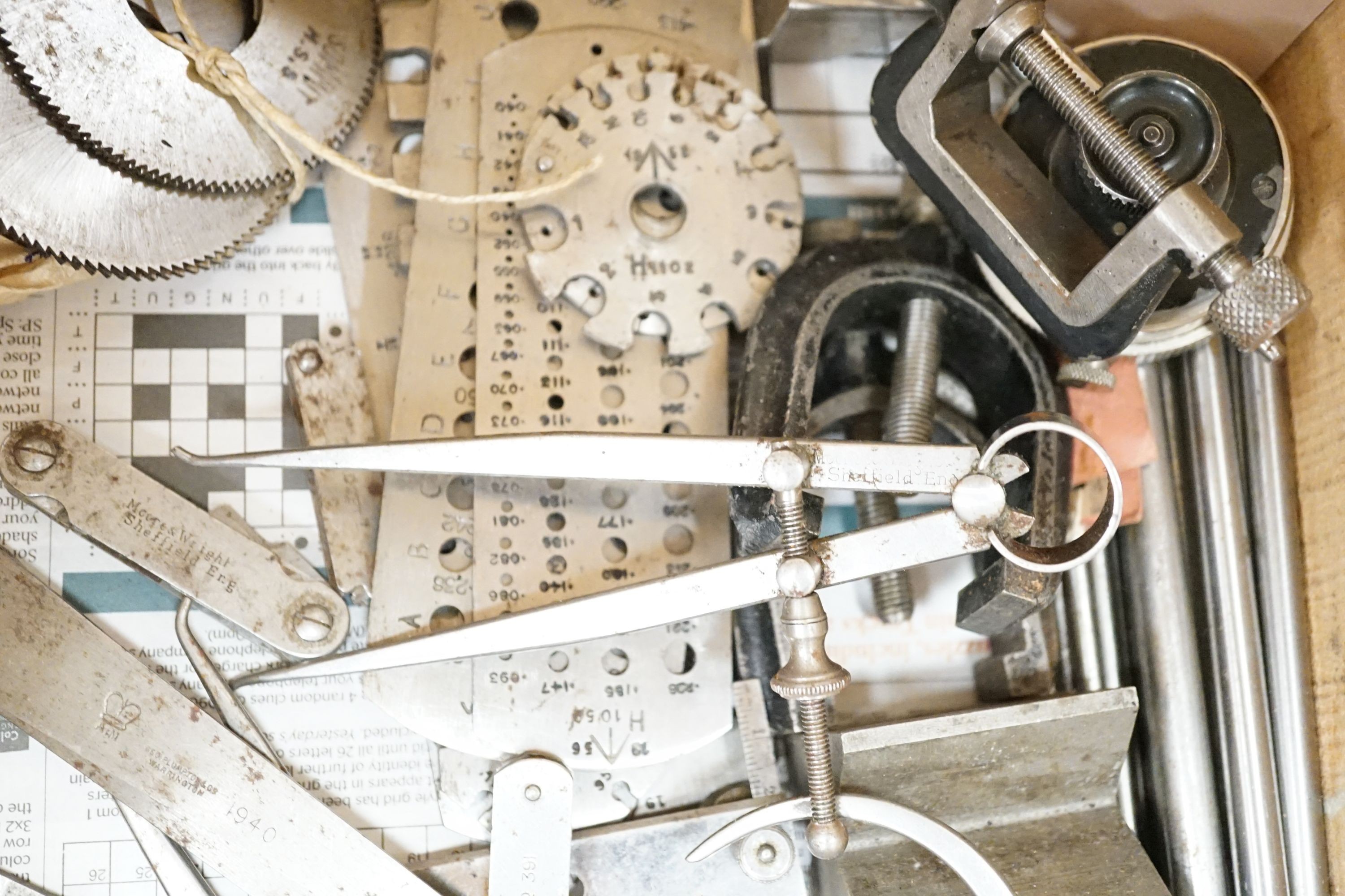 A collection of 20th century high precision metal measuring devices, including callipers, Compac dial micrometers, feeler gauges, wire gauges, a set square, steel cutting wheels etc